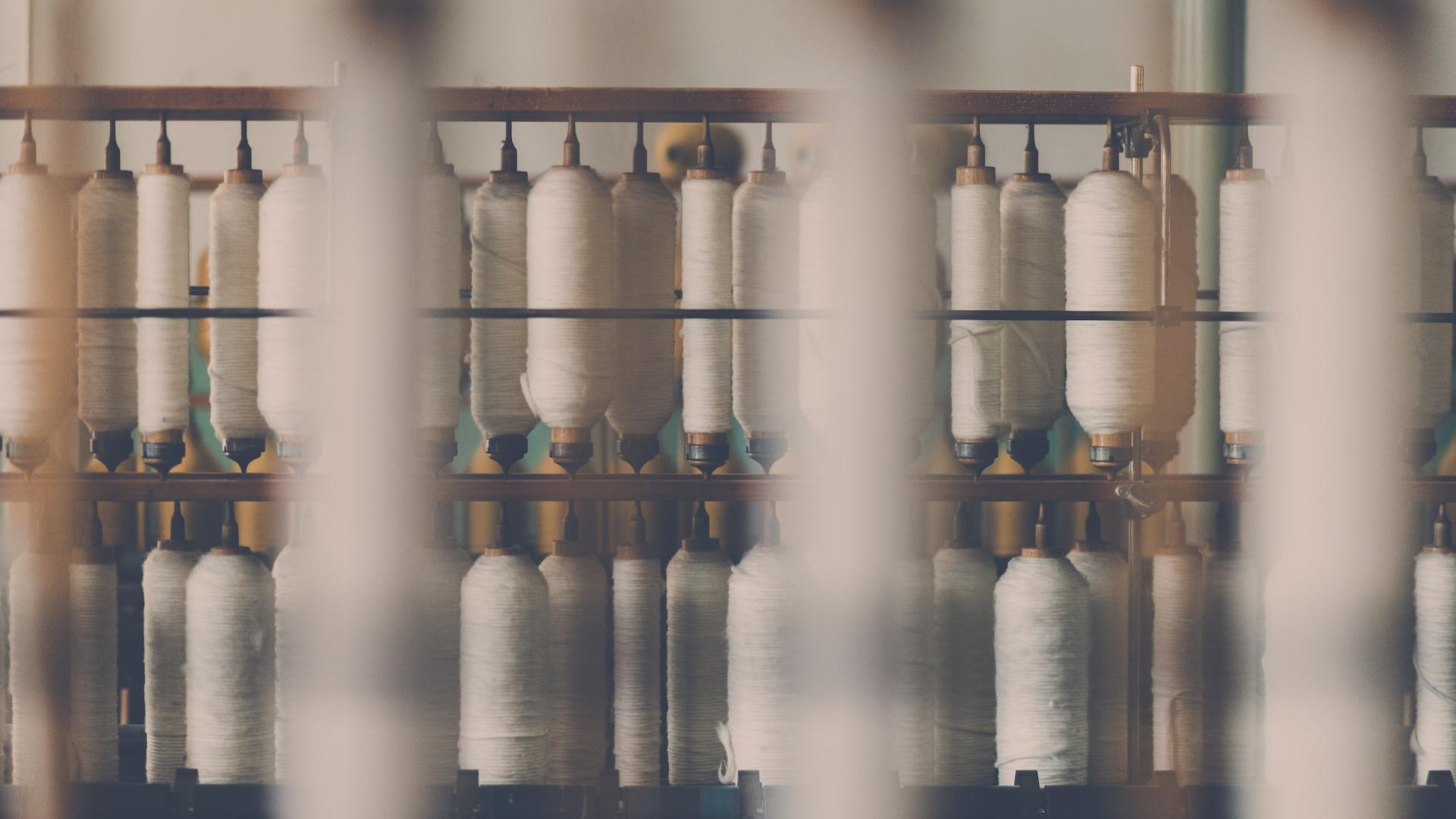 photography of white treadle on brown wooden rack